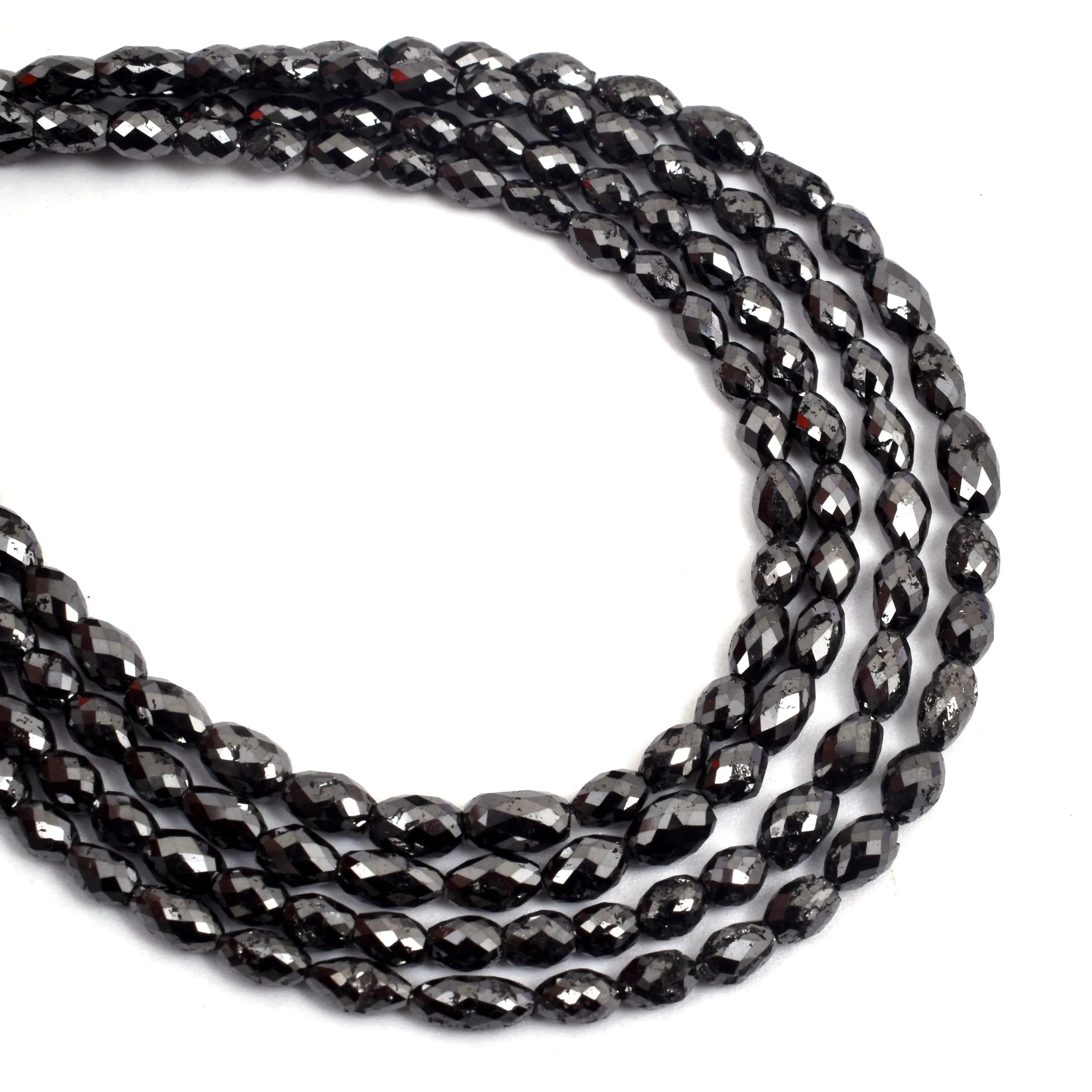 String of black beads on a white background