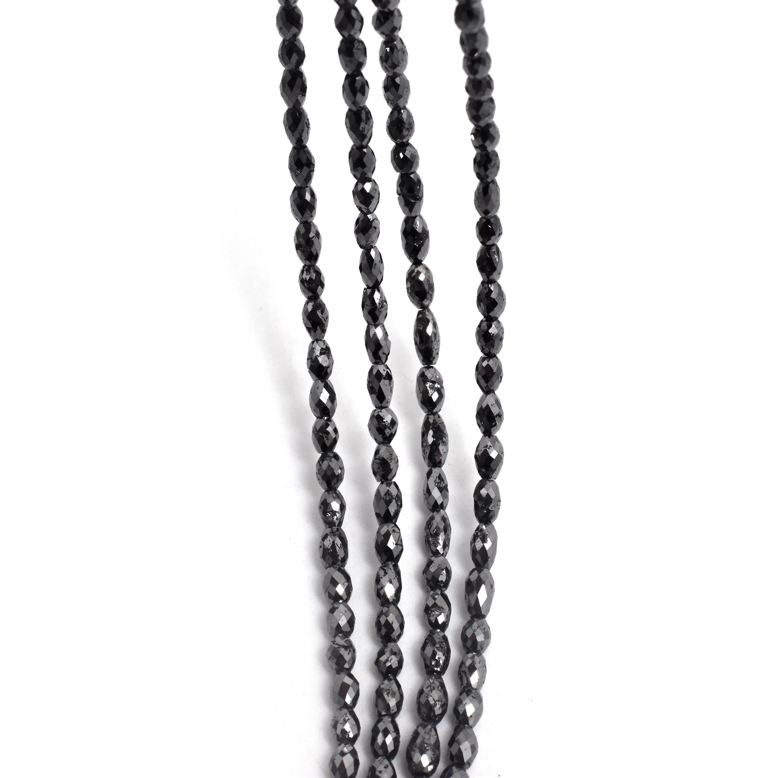 Two strands of black beaded necklace on a white background