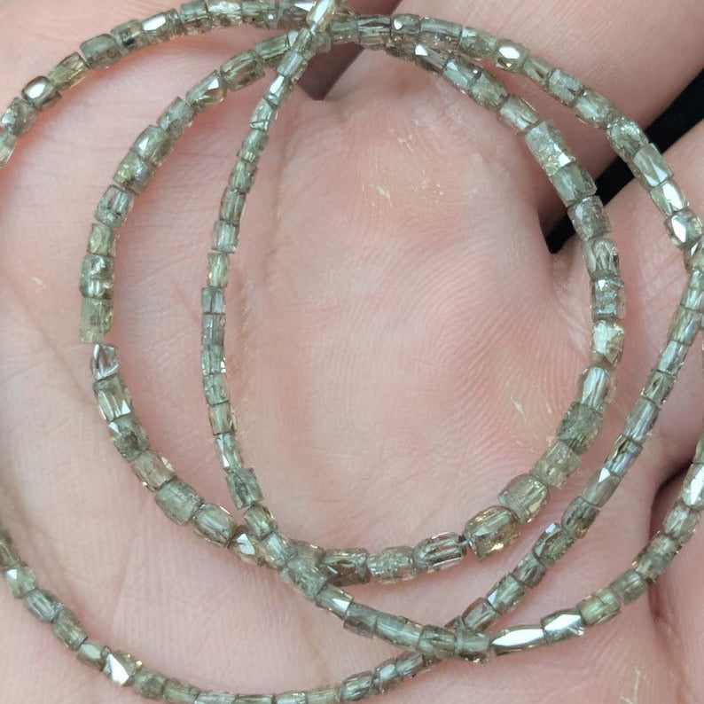 Two beaded bracelets on a person's wrist