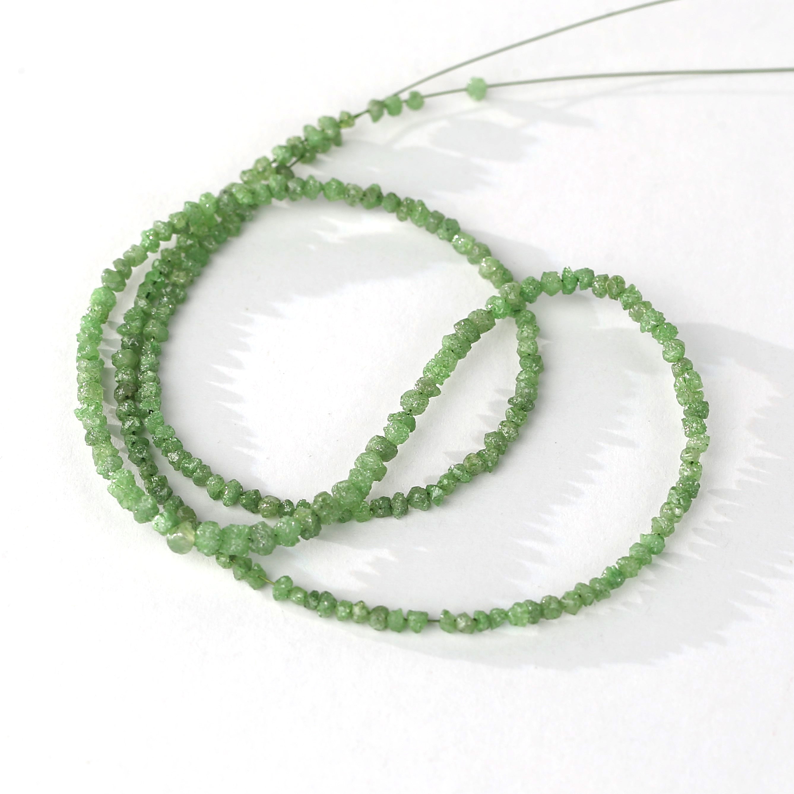 Raw green diamond faceted beads in wire strand