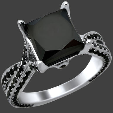 A black princess cut diamond engagement ring with pave set side stones in 14k white gold.