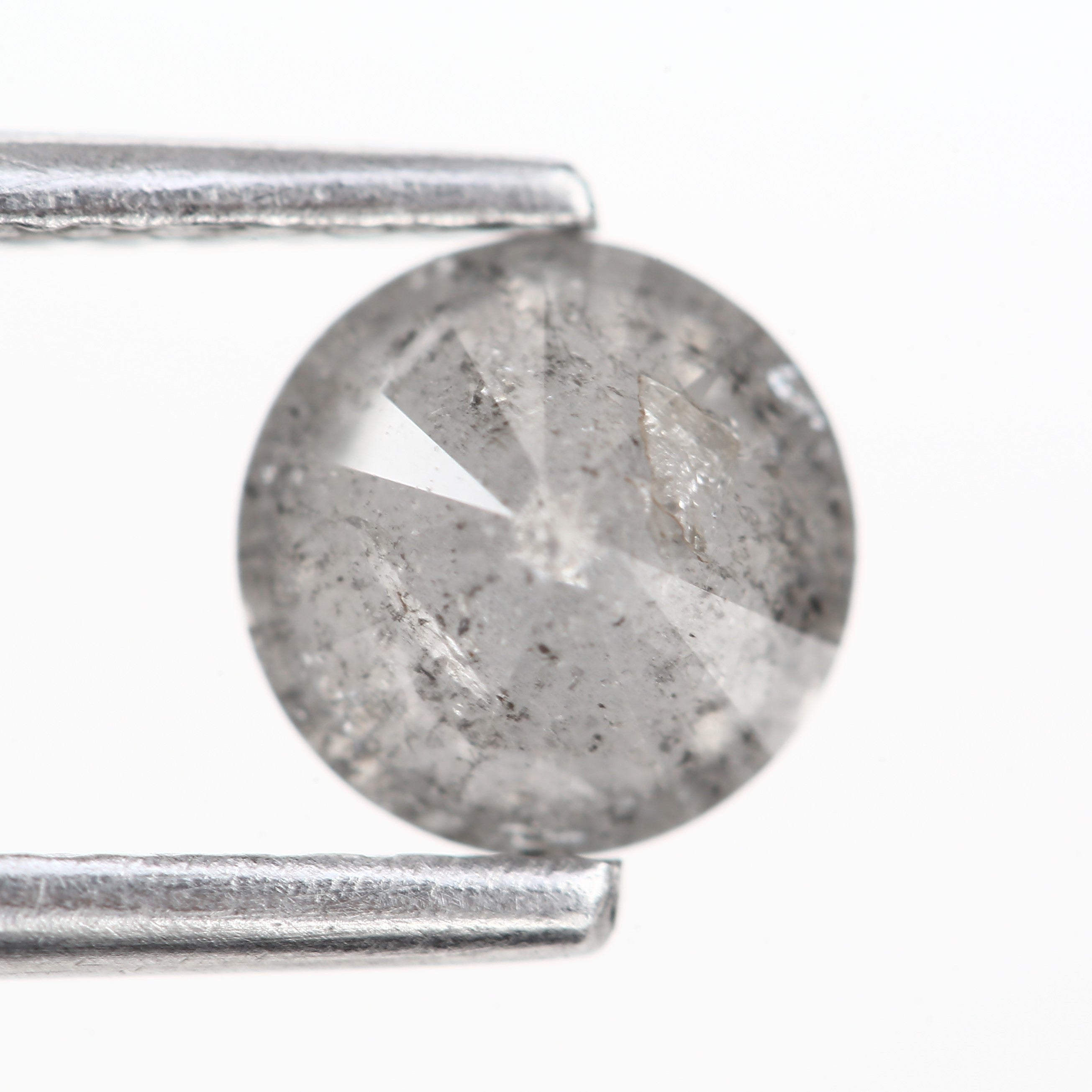 Natural gray round speckled diamond, loose stone ideal for unique engagement rings or custom jewelry designs.
